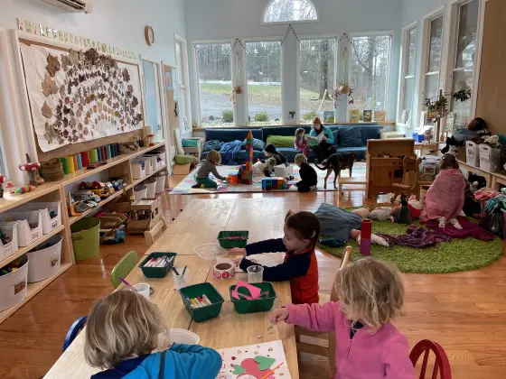 A cozy, rustic classroom space with natural light and wooden elements.